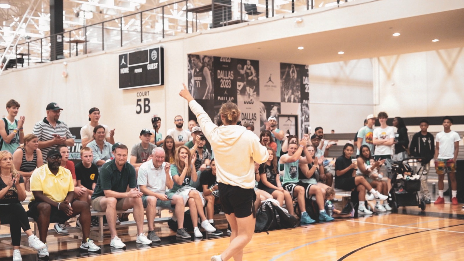Energy Steve performing courtside for a packed gym crowd at Jordan Brand Dallas 2023